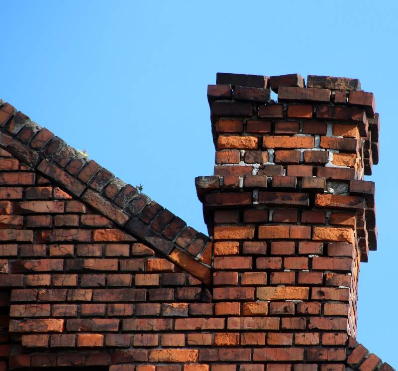 Damaged chimney on an Halifax home showing cracks and missing mortar